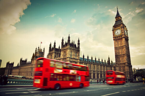 Red double-decker buses in London near Big Ben